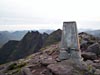 Trig point on Bidean a' Ghlas Thuill with Sgurr Fiona and the pinnacles behind